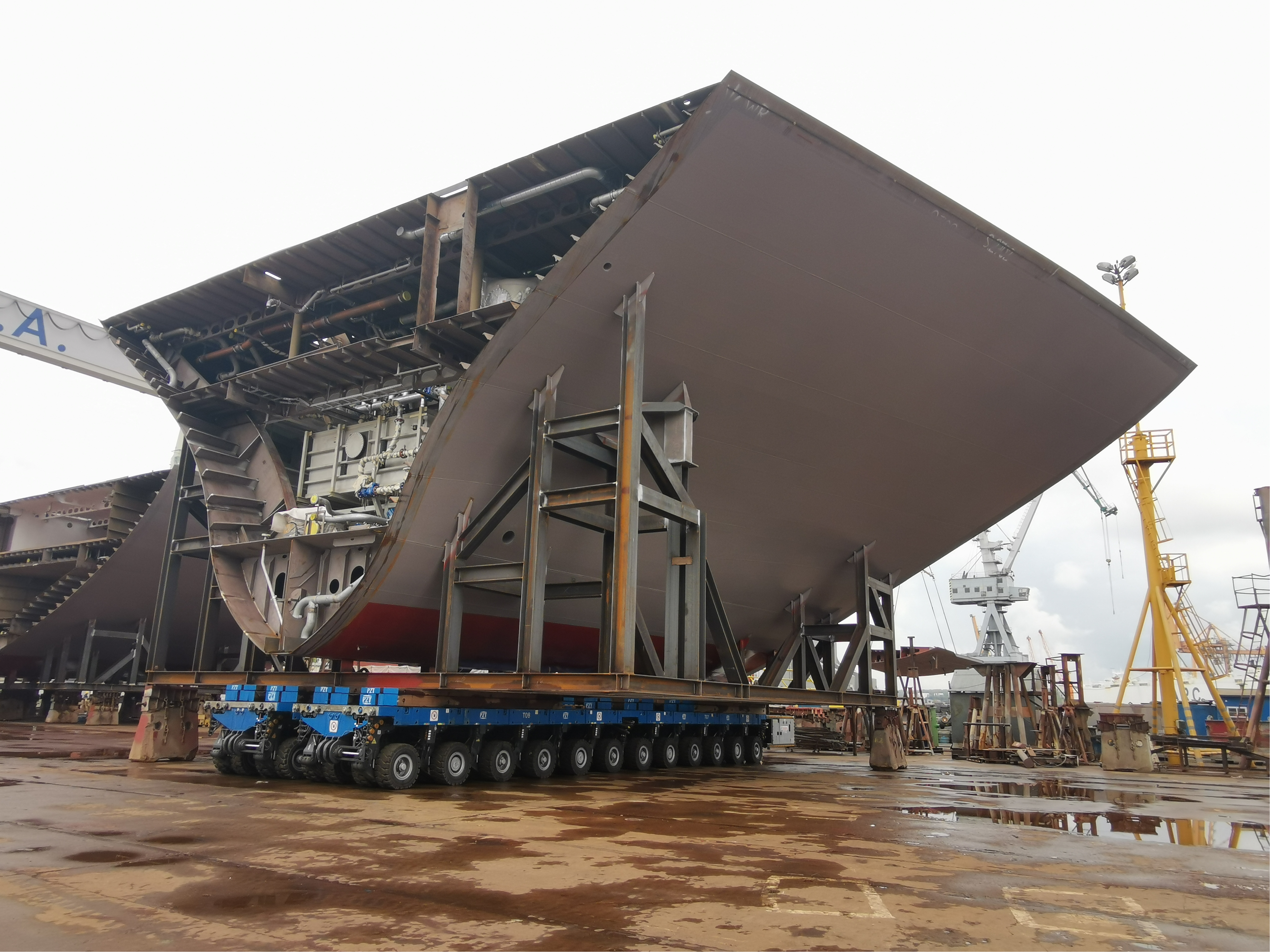 SPMT transports a part of a ship's hull