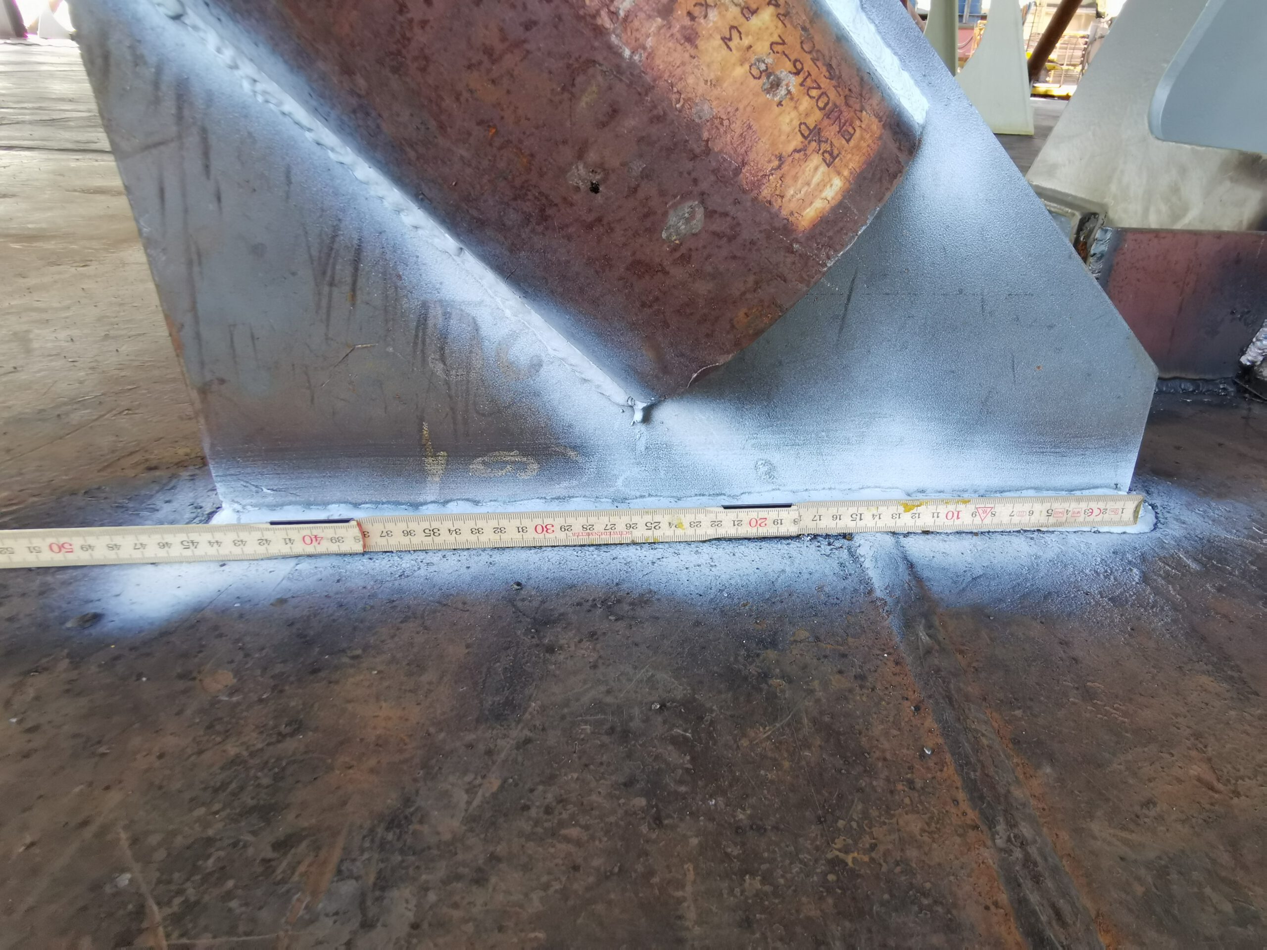 Checking the length of a weld seam on the deck of a ship